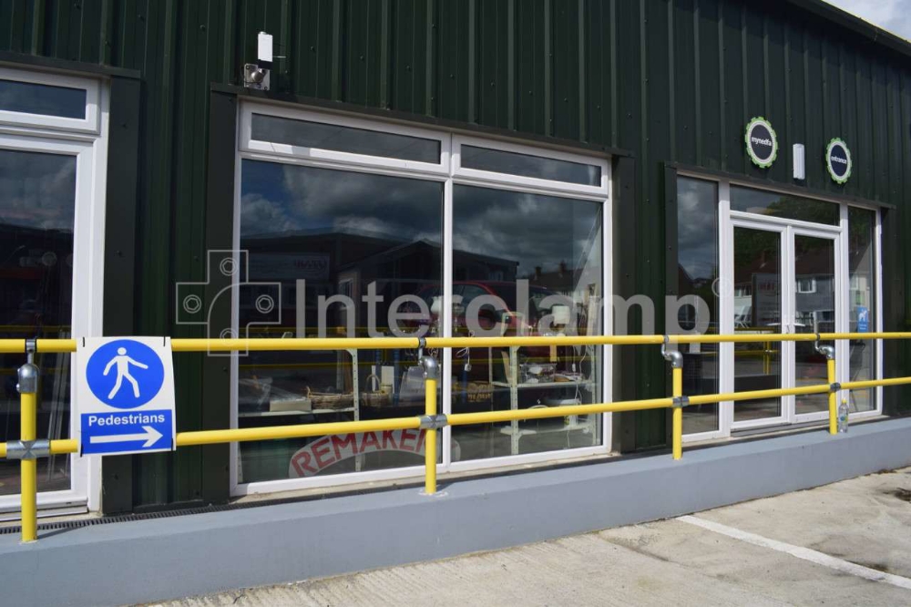 Tube clamp fittings used for handrailing along shop front.